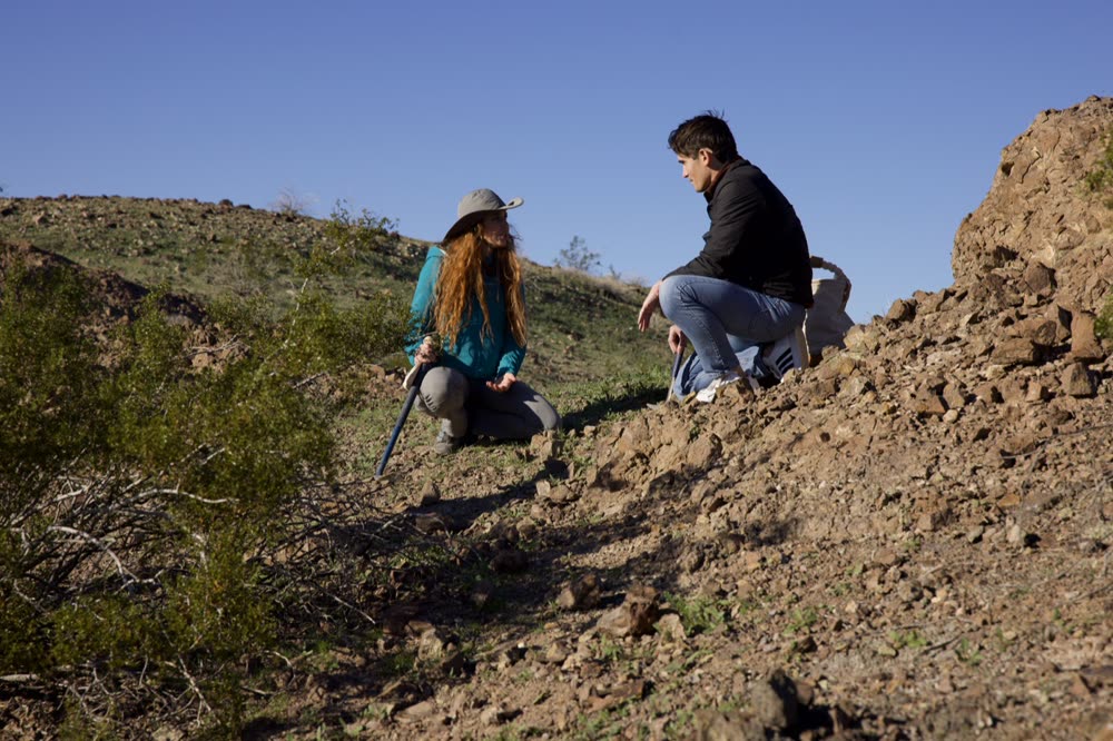 Host and guest working a hillside on location