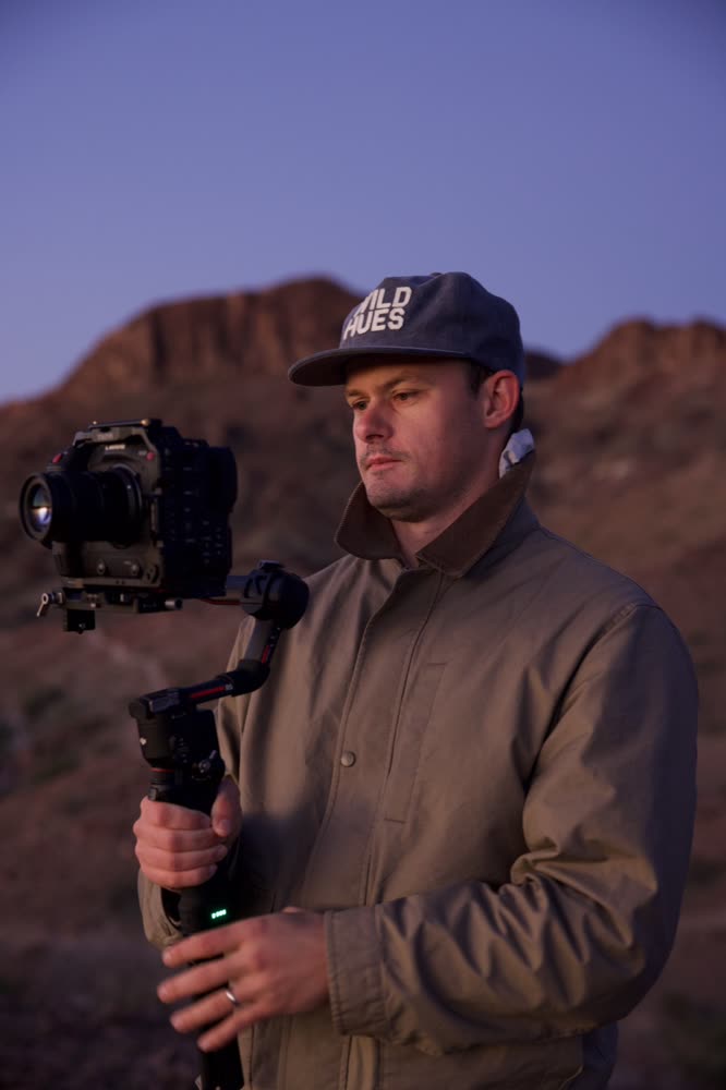 Camera operator shooting handheld at golden hour